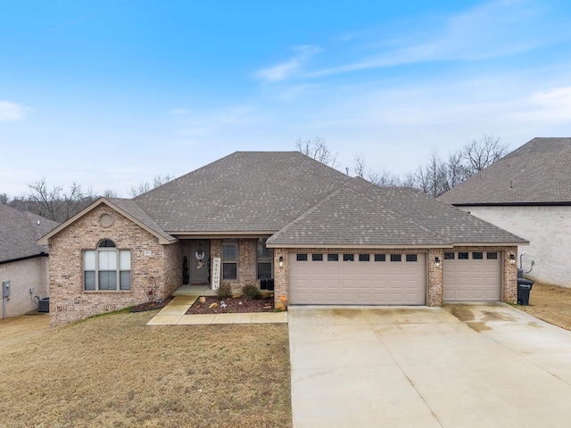 view of front of house with a garage, a front lawn, and central air condition unit