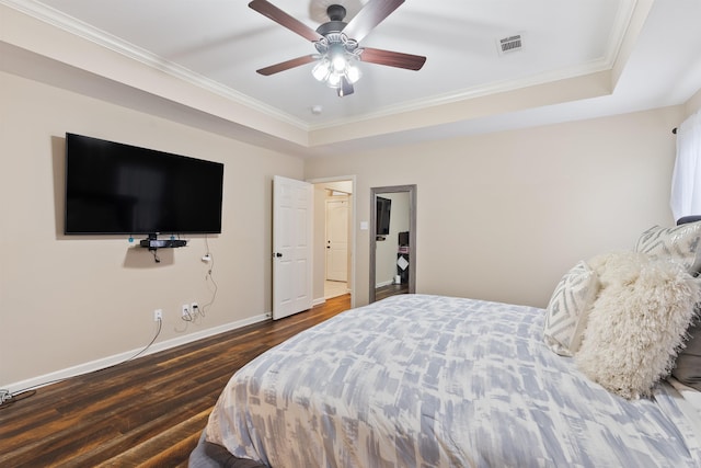 bedroom featuring dark wood-type flooring, ceiling fan, crown molding, and a raised ceiling