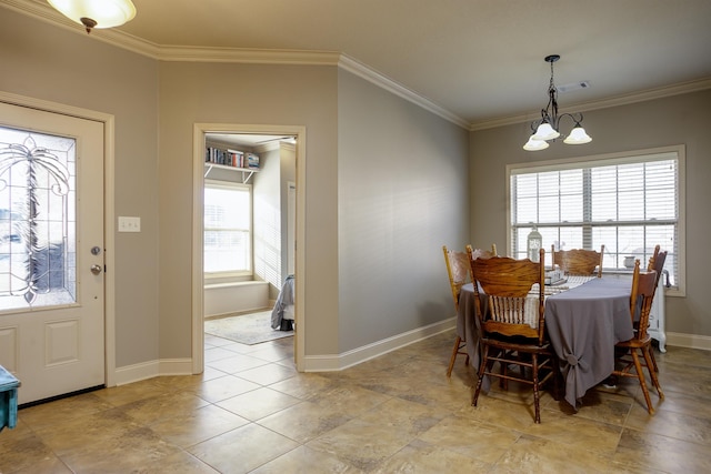 dining room featuring an inviting chandelier, crown molding, and plenty of natural light