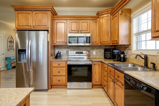 kitchen featuring sink, crown molding, tasteful backsplash, light hardwood / wood-style flooring, and stainless steel appliances