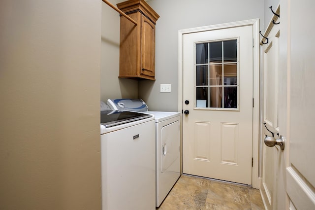 laundry area featuring washer and dryer and cabinets