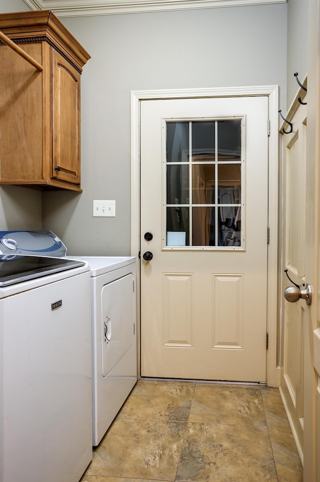 washroom featuring independent washer and dryer and cabinets