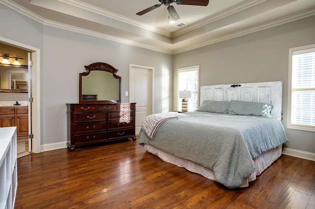 bedroom featuring multiple windows, a raised ceiling, ornamental molding, and dark hardwood / wood-style flooring