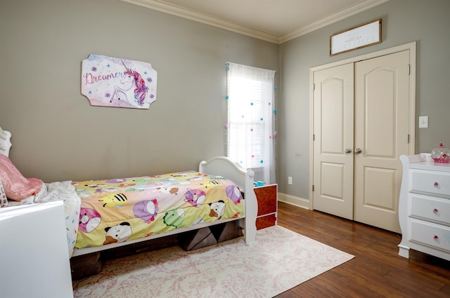 bedroom featuring ornamental molding, dark wood-type flooring, and a closet