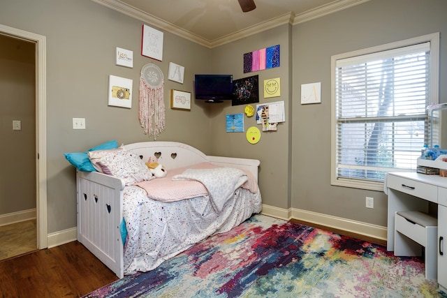 bedroom with crown molding, dark hardwood / wood-style floors, and ceiling fan