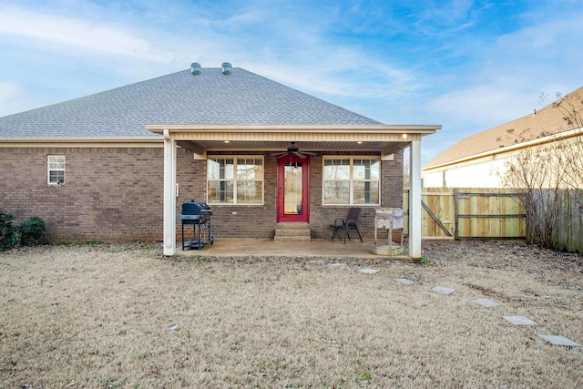 rear view of property with a patio area and ceiling fan