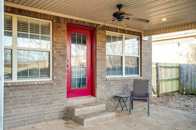 view of exterior entry featuring a patio and ceiling fan