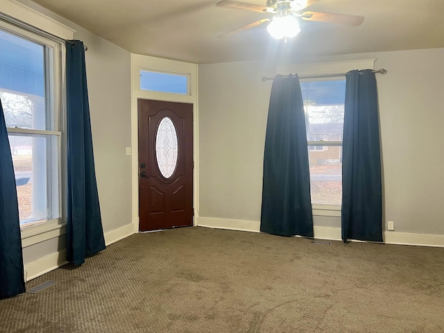 carpeted foyer entrance with ceiling fan