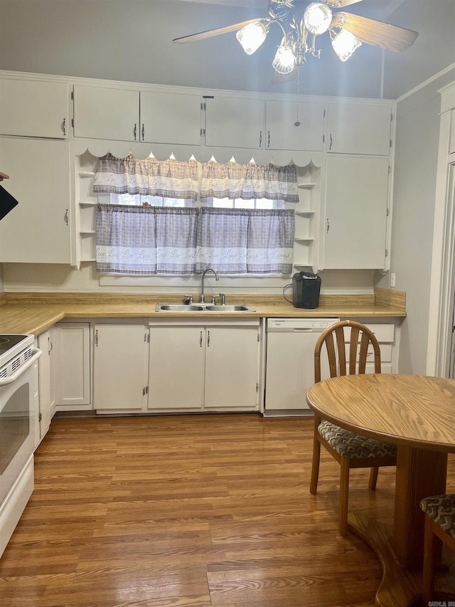 kitchen with white cabinetry, sink, white appliances, and light hardwood / wood-style floors