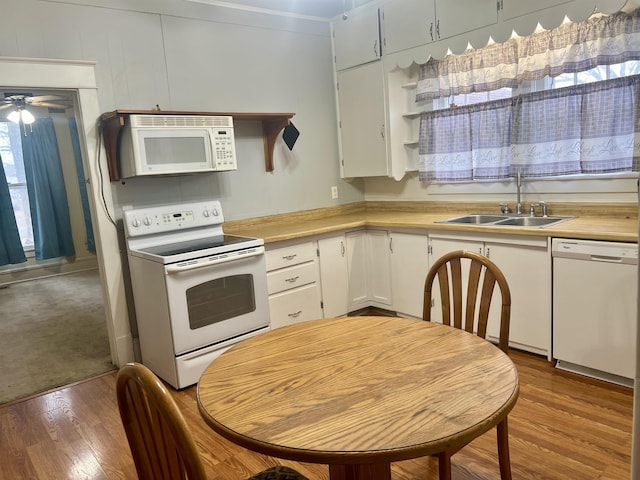 kitchen with sink, light wood-type flooring, white cabinets, ceiling fan, and white appliances