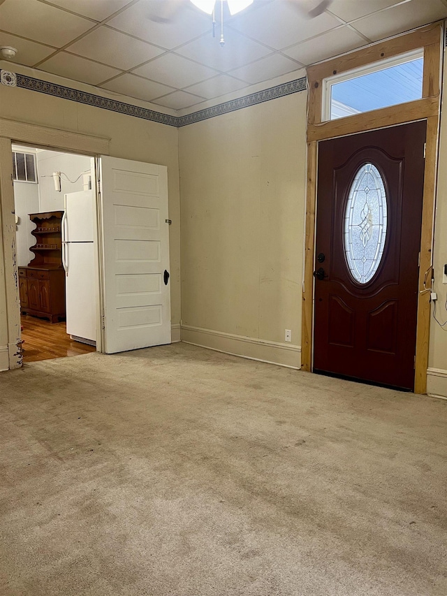 carpeted entryway featuring a paneled ceiling