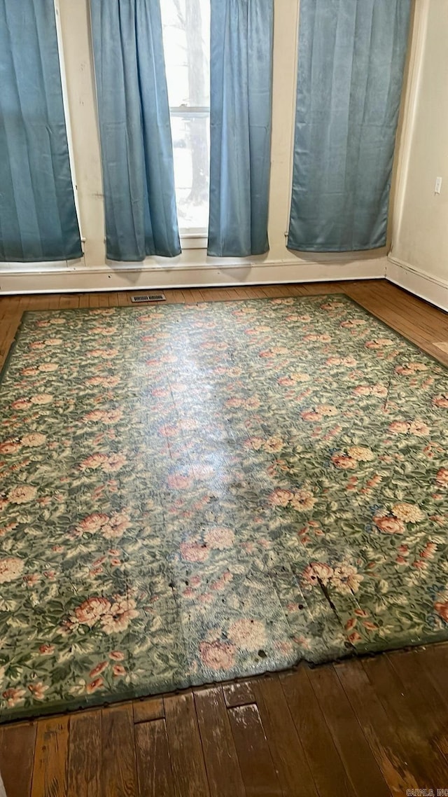 unfurnished room with hardwood / wood-style flooring