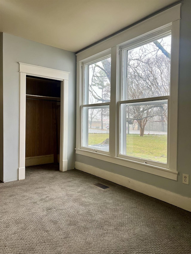 unfurnished bedroom with carpet floors and a closet