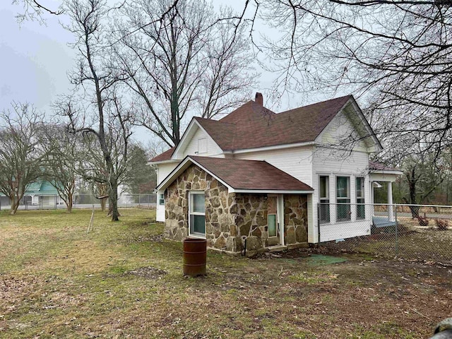 view of side of property with a yard