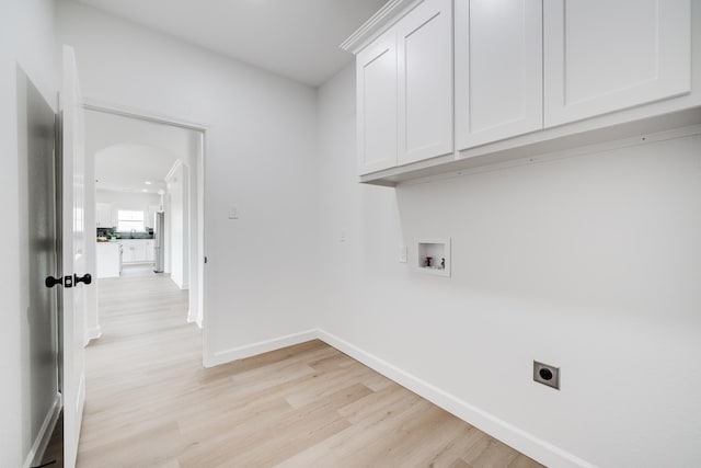 washroom with cabinets, hookup for an electric dryer, hookup for a washing machine, and light hardwood / wood-style floors