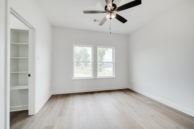 empty room featuring ceiling fan and light wood-type flooring