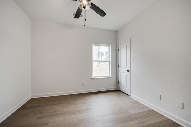 spare room with ceiling fan and light wood-type flooring