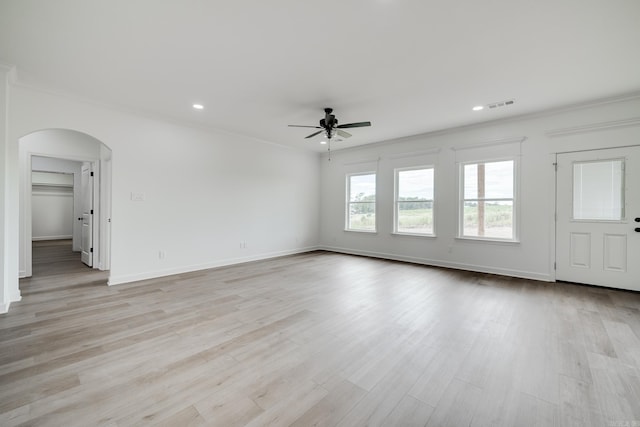 unfurnished room featuring crown molding, ceiling fan, and light wood-type flooring