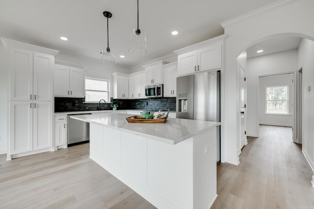 kitchen with white cabinetry, a kitchen island, and appliances with stainless steel finishes