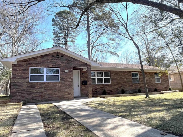 ranch-style home with a front lawn