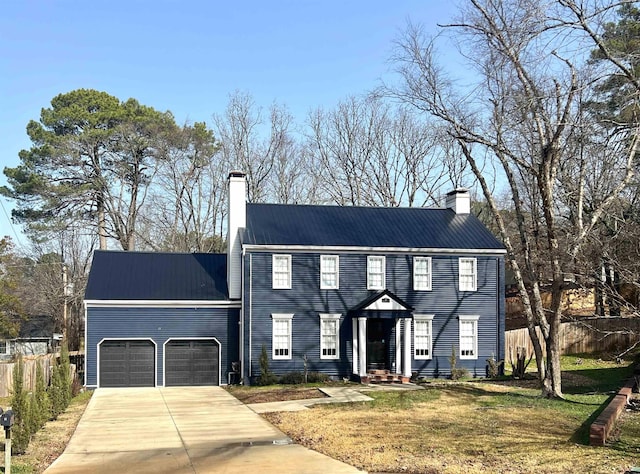 colonial-style house featuring a garage and a front lawn