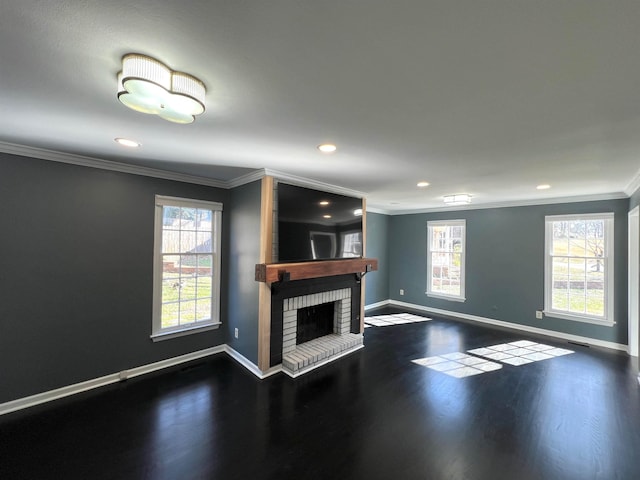 unfurnished living room featuring crown molding, dark hardwood / wood-style floors, and a brick fireplace