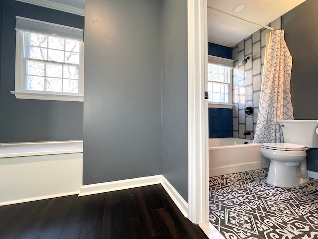 bathroom with shower / tub combo, hardwood / wood-style floors, and toilet