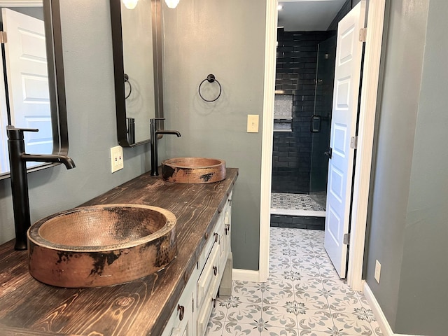 bathroom featuring vanity and a tile shower