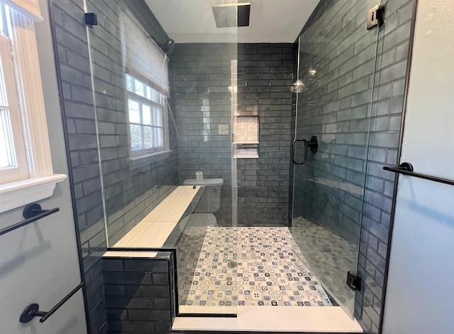 bathroom with a shower with door