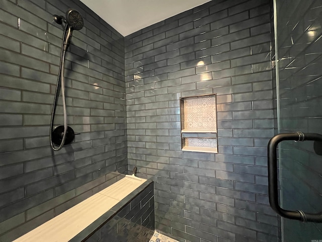 bathroom with tiled shower