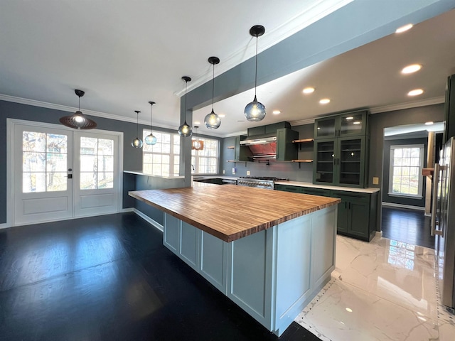 kitchen featuring wooden counters, stove, ornamental molding, decorative light fixtures, and french doors