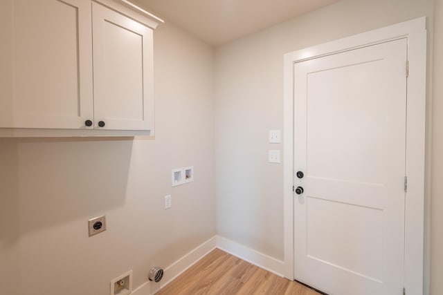 washroom featuring cabinets, hookup for a washing machine, light hardwood / wood-style floors, and hookup for an electric dryer