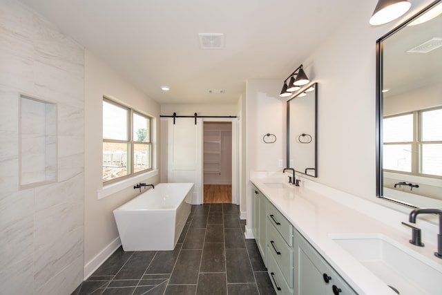 bathroom with vanity, a washtub, and tile patterned floors