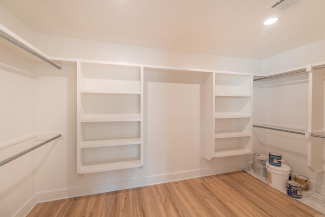 spacious closet with hardwood / wood-style flooring