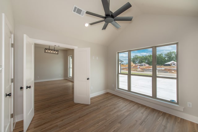 unfurnished room featuring ceiling fan, high vaulted ceiling, and hardwood / wood-style floors