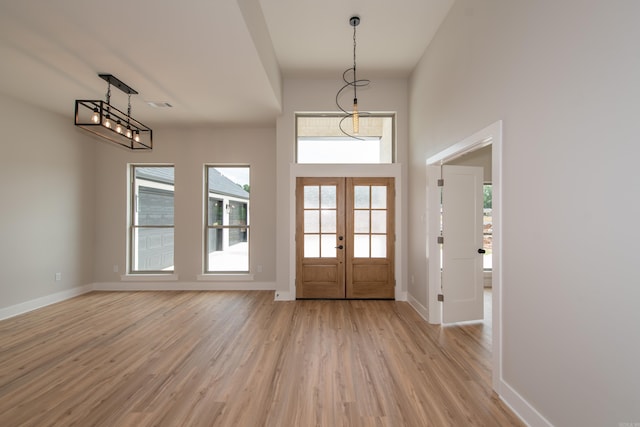 entrance foyer featuring french doors, visible vents, light wood-style flooring, and baseboards