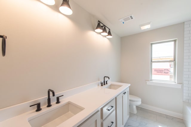 bathroom featuring vanity, a bathtub, and toilet