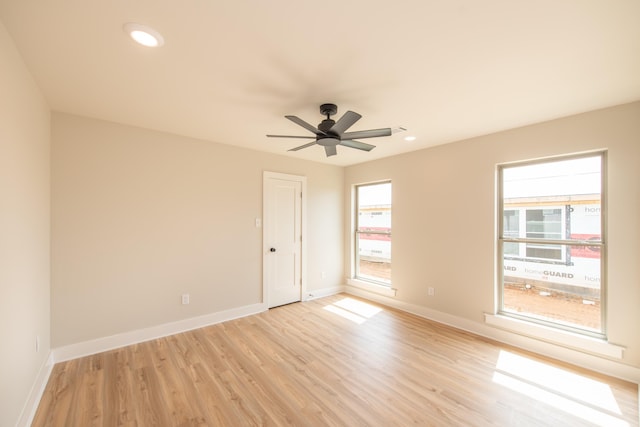 spare room featuring ceiling fan and light hardwood / wood-style flooring