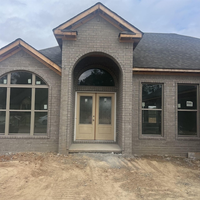 view of exterior entry featuring french doors