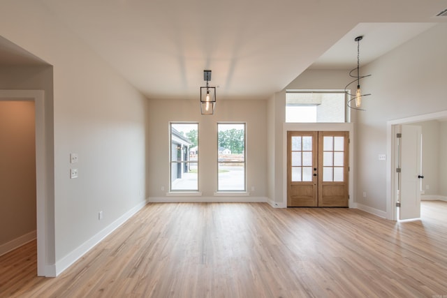 interior space featuring french doors and light hardwood / wood-style floors