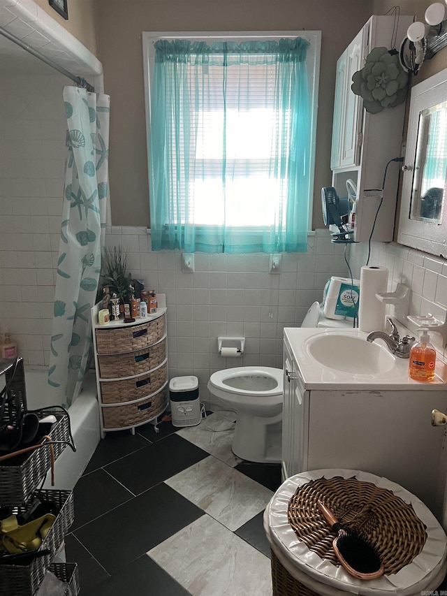 full bathroom featuring shower / tub combo, vanity, tile walls, and toilet