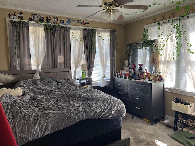 bedroom featuring ceiling fan, crown molding, light colored carpet, and a textured ceiling