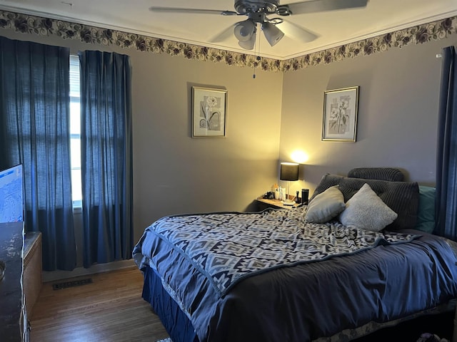 bedroom with hardwood / wood-style flooring and ceiling fan