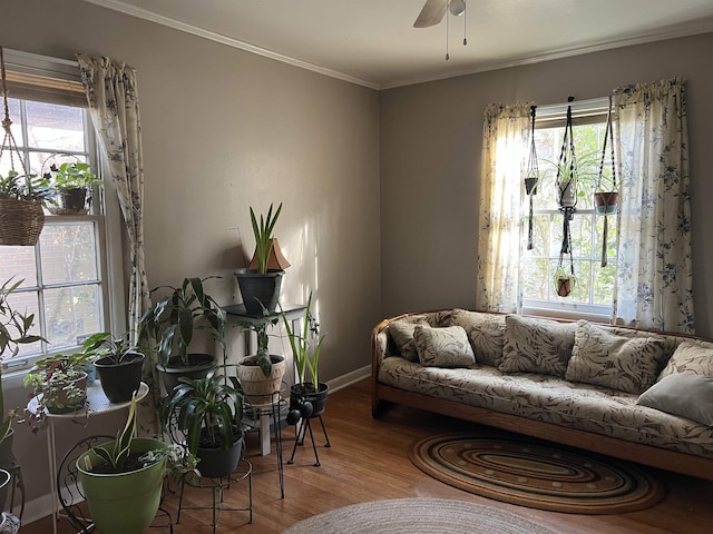 living area with hardwood / wood-style flooring, crown molding, and plenty of natural light