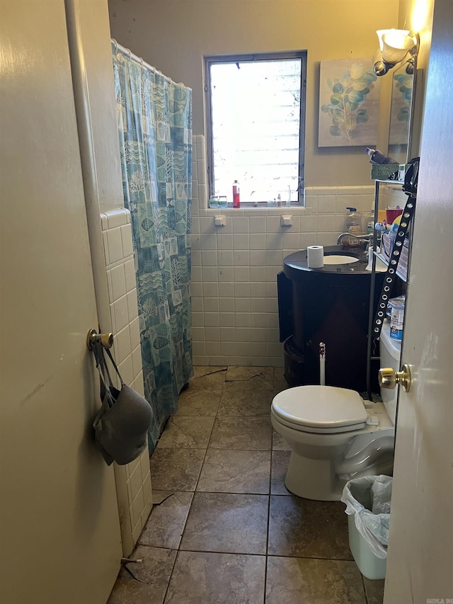 bathroom with a shower with curtain, tile walls, and toilet