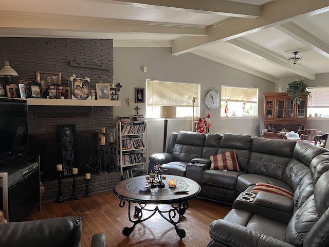 living room featuring a fireplace, lofted ceiling with beams, and wood-type flooring