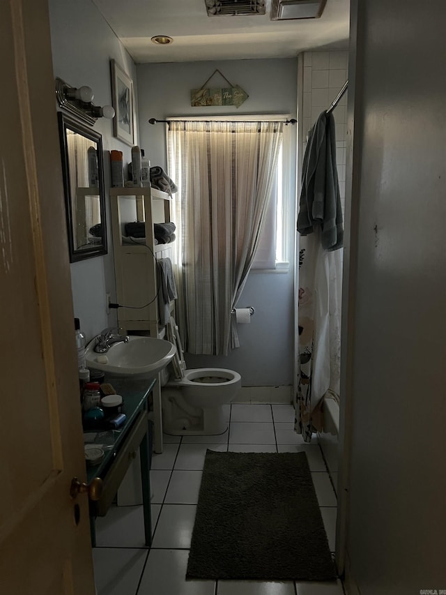 full bathroom featuring tile patterned flooring, vanity, shower / bath combination with curtain, and toilet