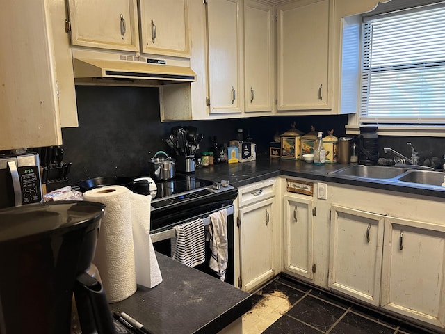 kitchen featuring sink and cream cabinetry