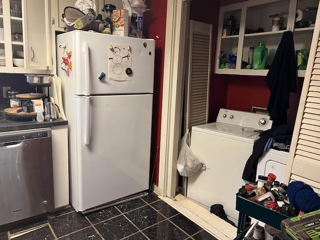 interior space featuring white refrigerator, stainless steel dishwasher, and washer / clothes dryer