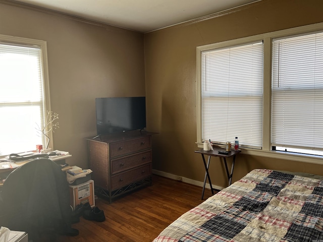 bedroom with dark hardwood / wood-style flooring